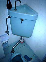Traditional Japaneese toilet with reuse of handwash water for flushing.