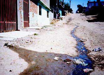 Gray water runs down a street in Tijuana, Mexico.