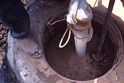 Sealing the upper portion of the well shaft with clay.