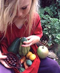 Girl with day's harvest from her edible landscape
